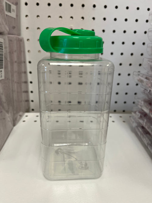 Clear plastic container with colored handle on a shelf